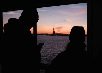 closeup of a couple by window on Staten Island ferry
