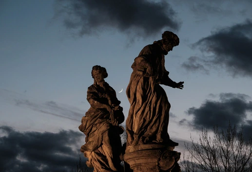 Statues on Prague Charles Bridge with Moon