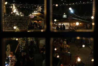 Christmas market from behind a window frame